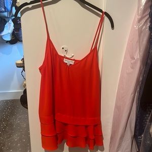 Red sleeveless blouse with ruffled bottom